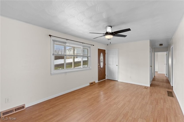 spare room featuring ceiling fan and light wood-type flooring