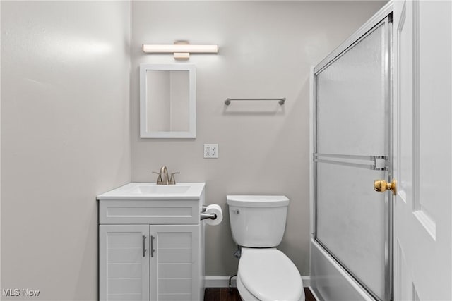 full bathroom with vanity, shower / bath combination with glass door, and toilet