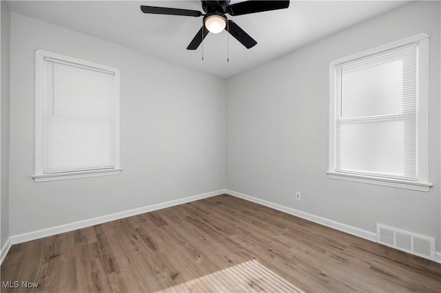 spare room featuring light hardwood / wood-style floors and ceiling fan