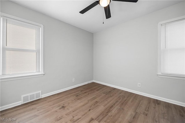 empty room featuring hardwood / wood-style flooring and ceiling fan