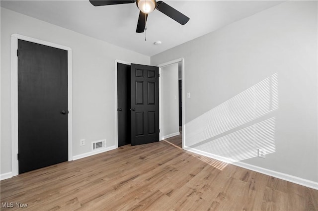 unfurnished bedroom with light hardwood / wood-style flooring and ceiling fan