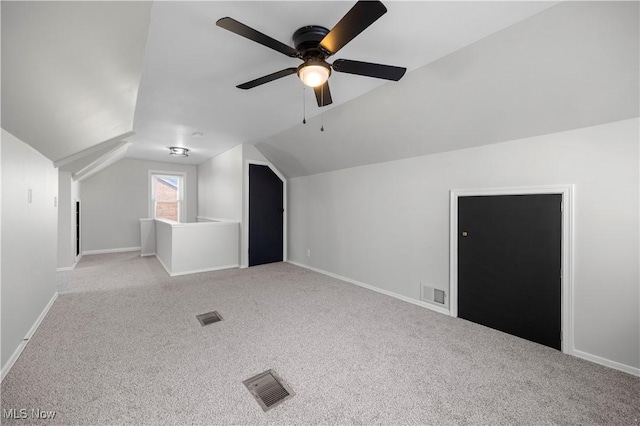 bonus room with light carpet, vaulted ceiling, and ceiling fan