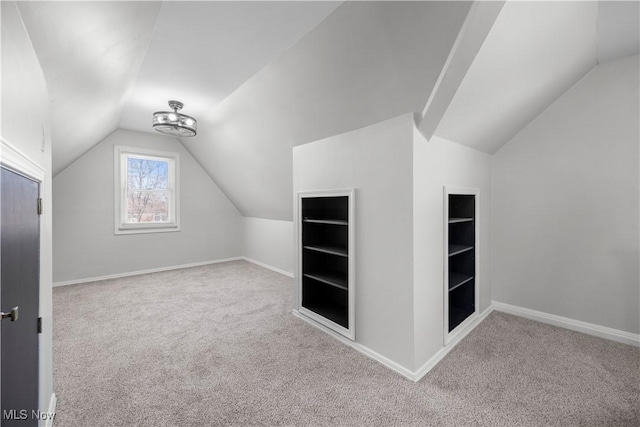 bonus room featuring light colored carpet and vaulted ceiling