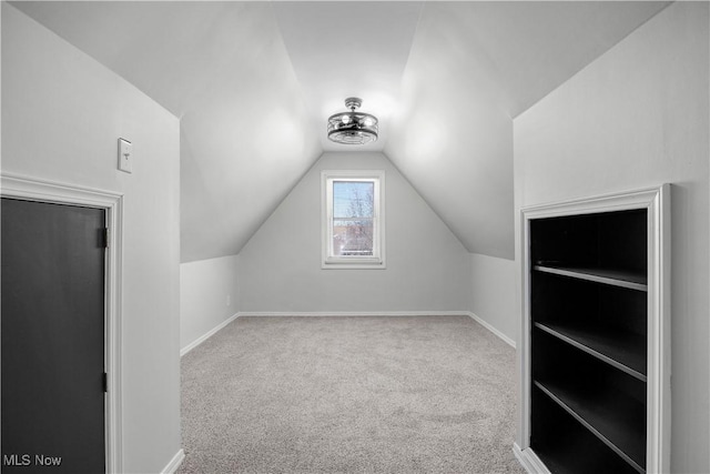 bonus room featuring vaulted ceiling and carpet floors