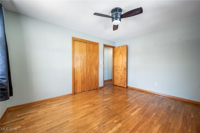 unfurnished bedroom with ceiling fan, light hardwood / wood-style floors, and a closet