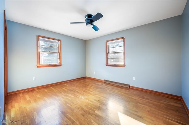 unfurnished room with ceiling fan, plenty of natural light, and light hardwood / wood-style flooring