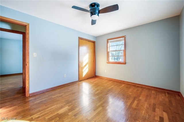 empty room featuring hardwood / wood-style floors and ceiling fan