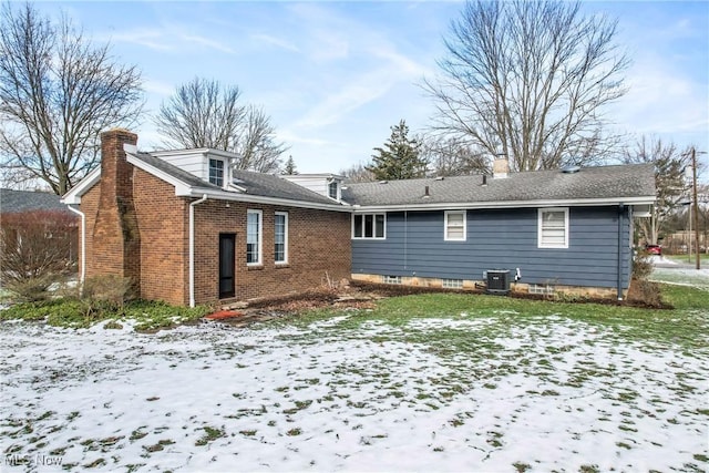 snow covered property featuring central air condition unit