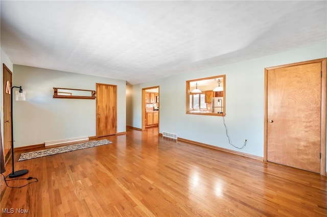 spare room with light hardwood / wood-style flooring