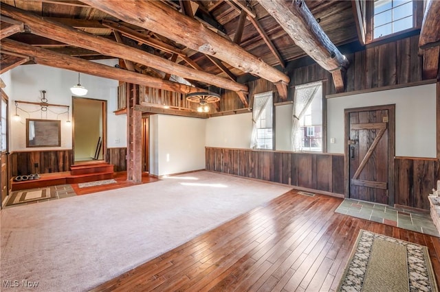 basement featuring wooden walls, hardwood / wood-style floors, and wooden ceiling