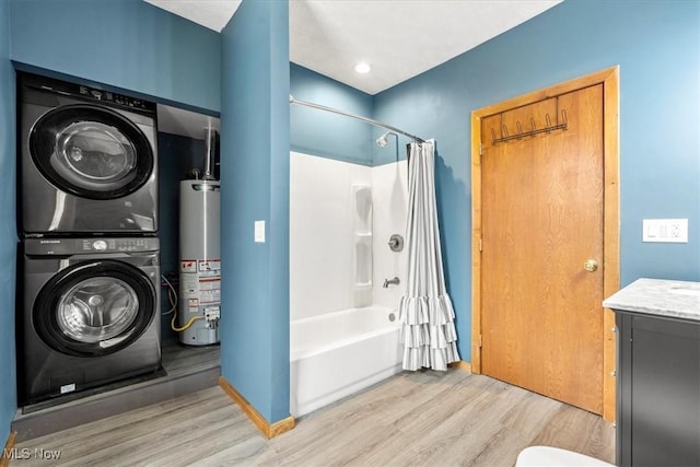 117 Franklin St, Marietta, OH 45750 - bathroom with gas water heater, estacked washer and dryer, wood finished floors, shower / bath combo with shower curtain, and vanity