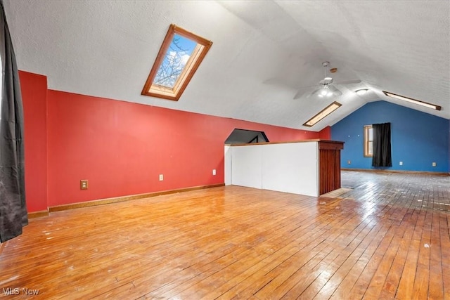 117 Franklin St, Marietta, OH 45750 - additional living space with wood-type flooring, vaulted ceiling, a skylight, and a ceiling fan