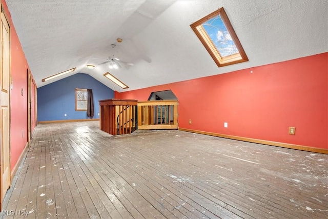 117 Franklin St, Marietta, OH 45750 - additional living space featuring a skylight, hardwood / wood-style floors, lofted ceiling, a ceiling fan, and a textured ceiling