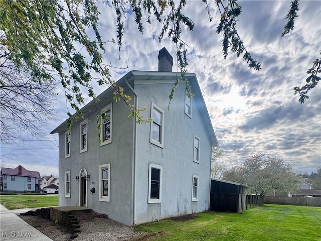 117 Franklin St, Marietta, OH 45750 - view of side of property with a chimney and stucco siding