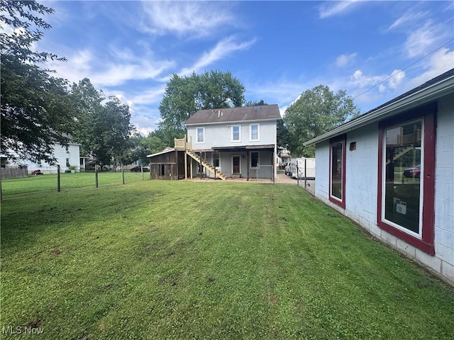 117 Franklin St, Marietta, OH 45750 - back of house with stairs, a lawn, and concrete block siding