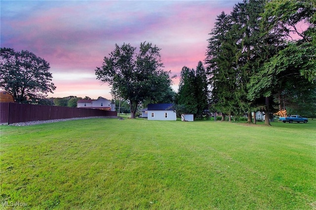 view of yard at dusk