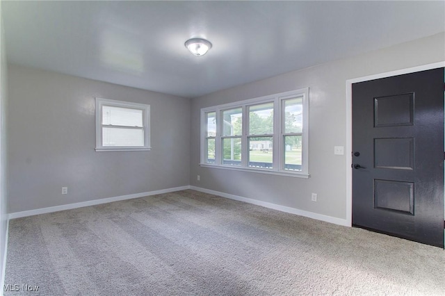 foyer entrance featuring carpet