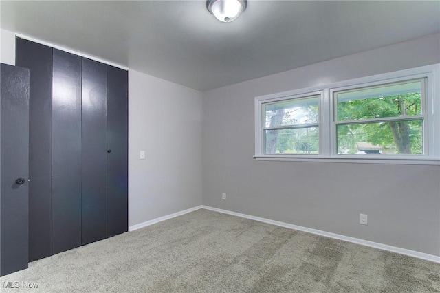 unfurnished bedroom featuring a closet and carpet