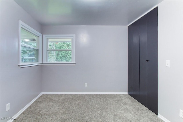 unfurnished room with carpet flooring