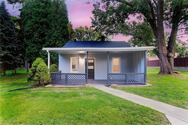 view of front of property with a yard and a porch