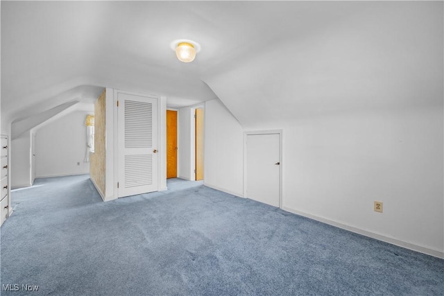 bonus room featuring lofted ceiling and carpet flooring