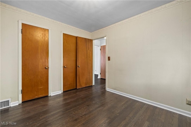 unfurnished bedroom with dark hardwood / wood-style flooring