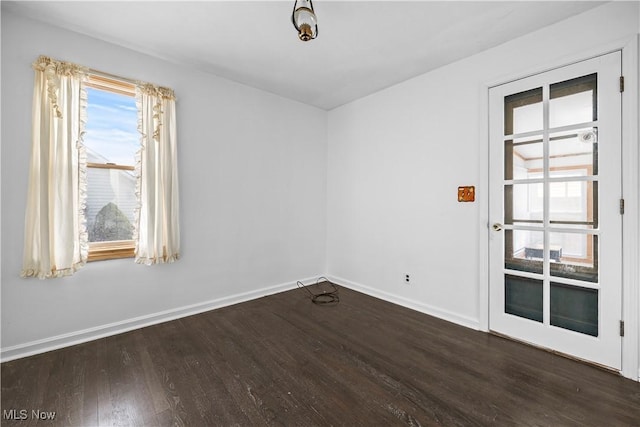 empty room with dark hardwood / wood-style floors