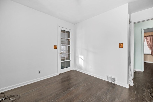 unfurnished room with dark wood-type flooring