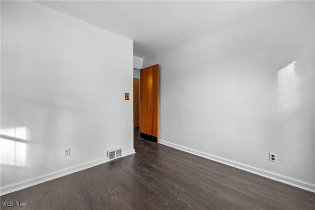 unfurnished room featuring dark hardwood / wood-style flooring