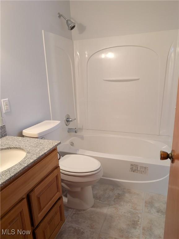 full bathroom featuring tile patterned flooring, vanity, washtub / shower combination, and toilet