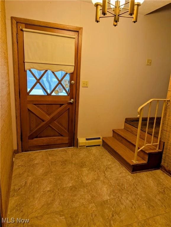 foyer with an inviting chandelier and a baseboard heating unit