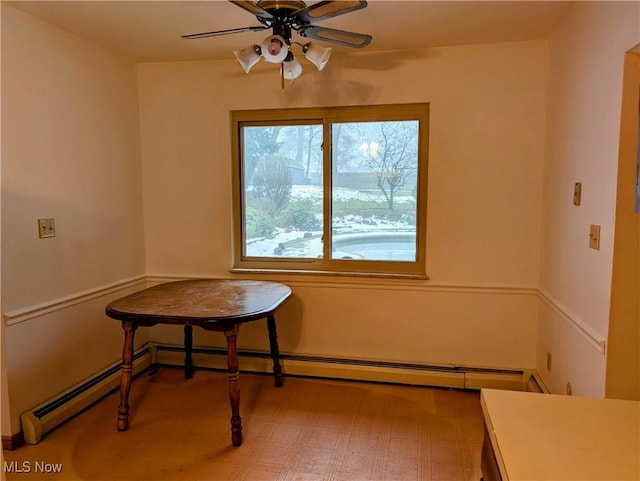 dining space with baseboard heating and ceiling fan