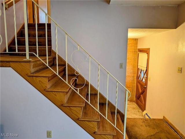 staircase with a baseboard radiator