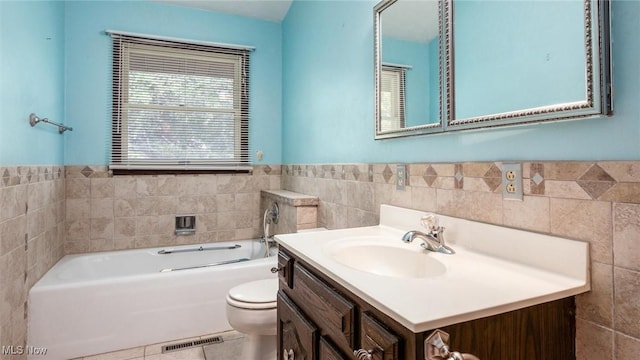 bathroom with vanity, a tub to relax in, toilet, and tile walls