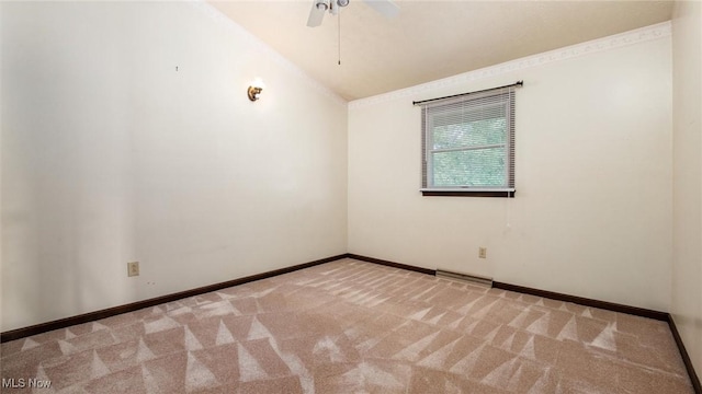 spare room with ceiling fan, ornamental molding, vaulted ceiling, and light carpet