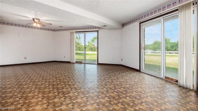 spare room featuring ceiling fan, parquet flooring, and a textured ceiling