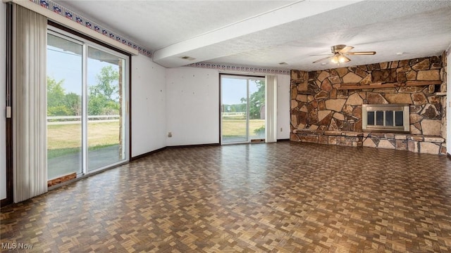 unfurnished living room featuring parquet floors, a fireplace, and a textured ceiling