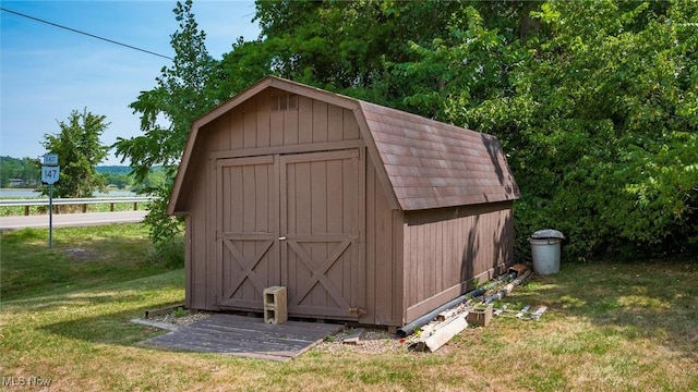 view of outbuilding with a yard