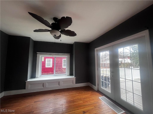 unfurnished room with french doors, ceiling fan, a healthy amount of sunlight, and light hardwood / wood-style floors