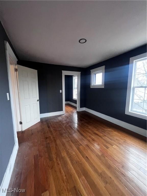 spare room with wood-type flooring