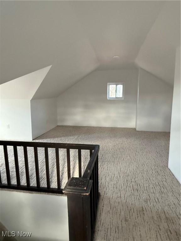 bonus room featuring lofted ceiling and carpet floors