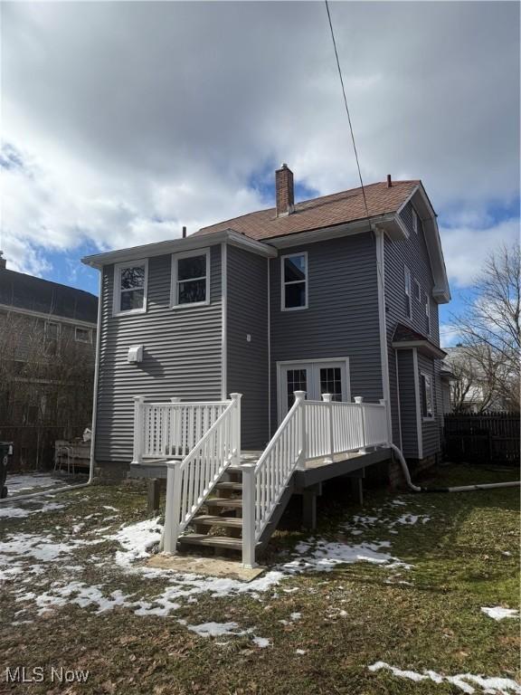 snow covered property with a deck