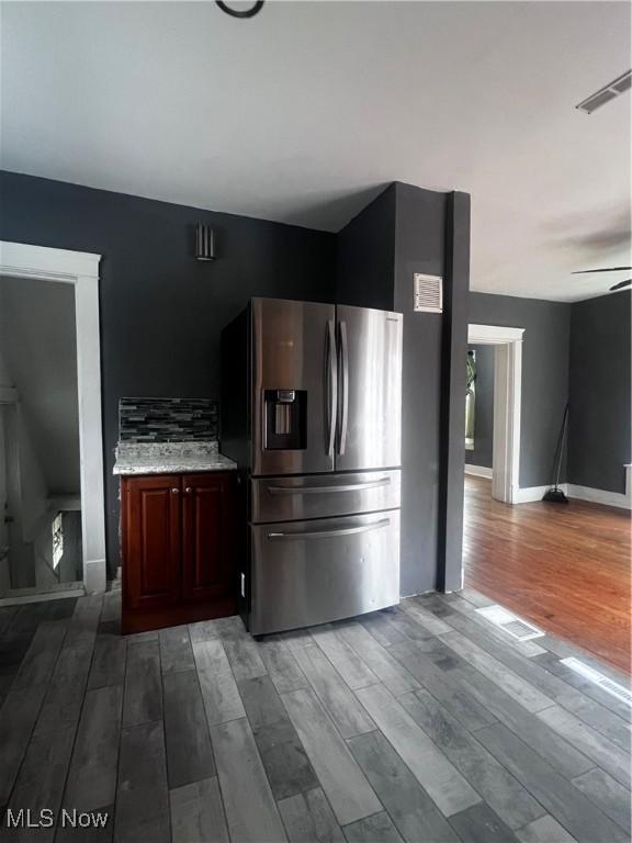 kitchen featuring hardwood / wood-style flooring, stainless steel fridge, and ceiling fan