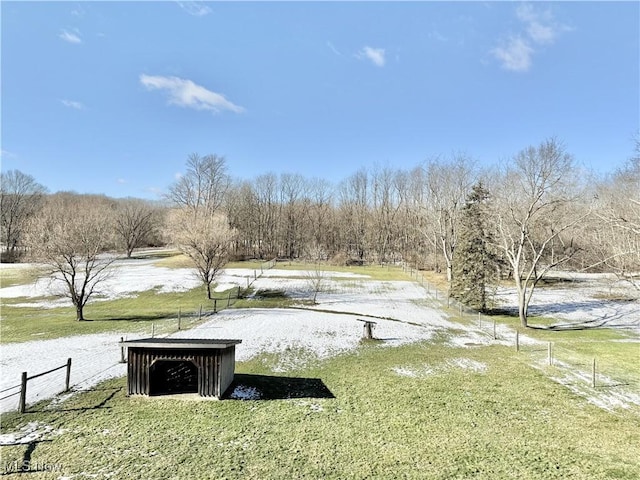 view of home's community with a rural view and a lawn