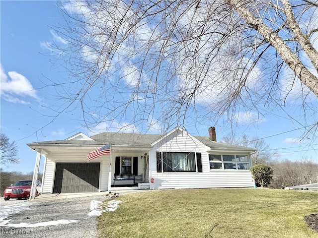 single story home with a garage, a front lawn, and a porch