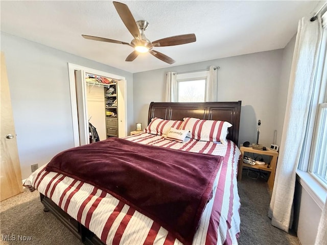 bedroom with dark carpet and ceiling fan