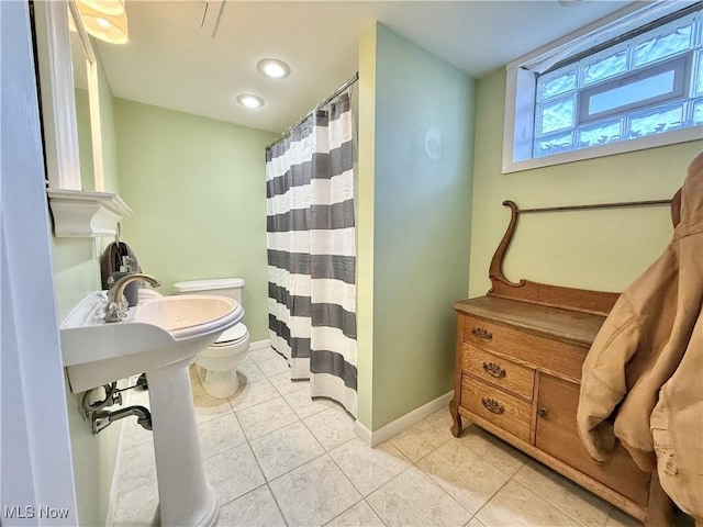 bathroom featuring toilet and tile patterned flooring