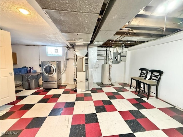 basement featuring electric panel, separate washer and dryer, heating unit, and gas water heater