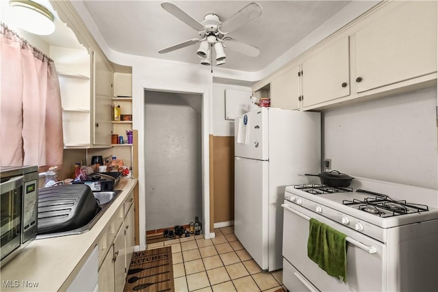 kitchen featuring sink, white appliances, ceiling fan, and light tile patterned flooring