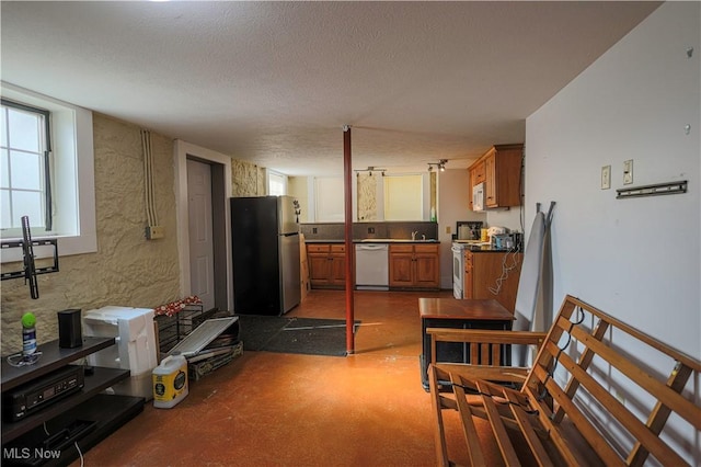 kitchen featuring white appliances and a textured ceiling